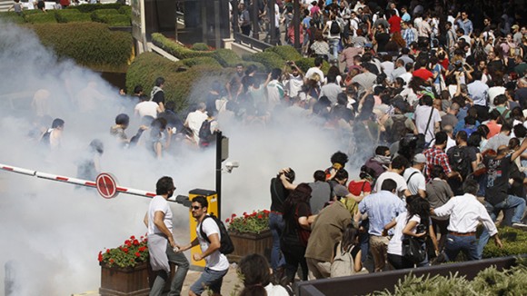 Turkish riot police use tear gas to disperse demonstrators during protest against destruction of trees in park brought about by pedestrian project, in Taksim Square in central Istanbul